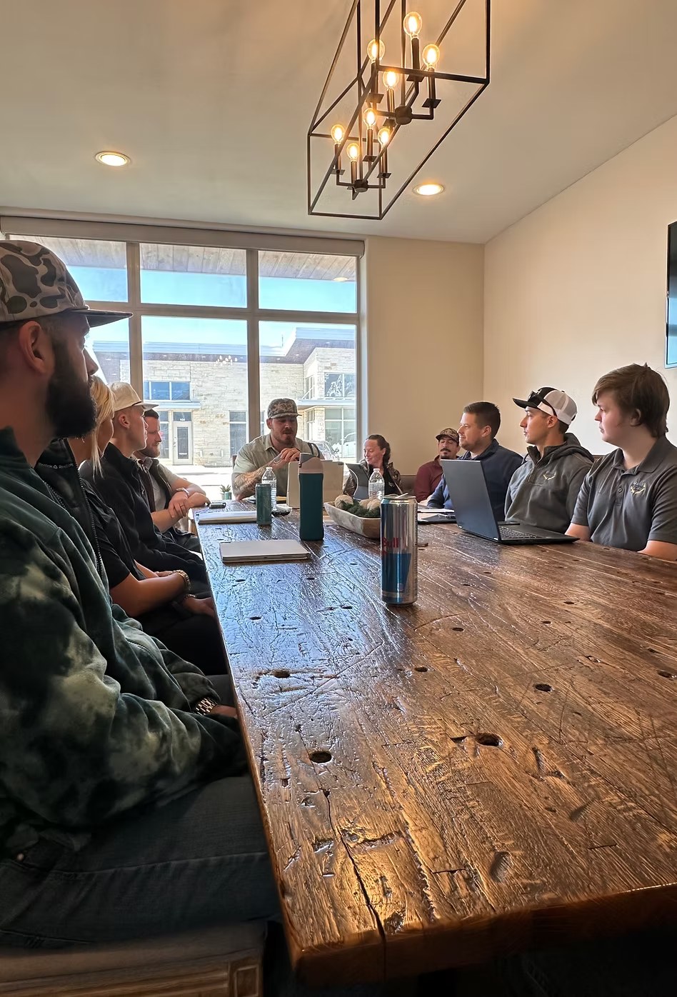 The Trophy Exteriors team meeting around the conference table